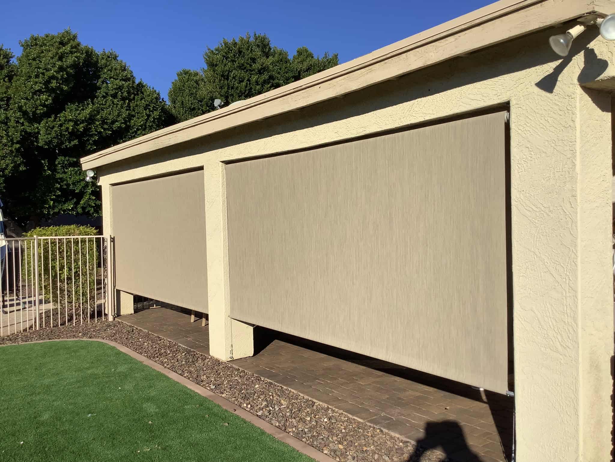High-quality retractable shade screens installed on a building for sun protection and privacy solution.