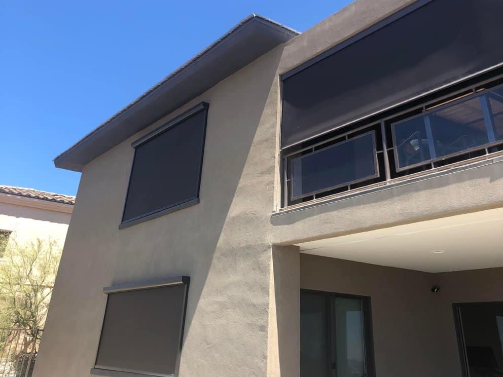 High-quality retractable window shades on a contemporary house exterior.