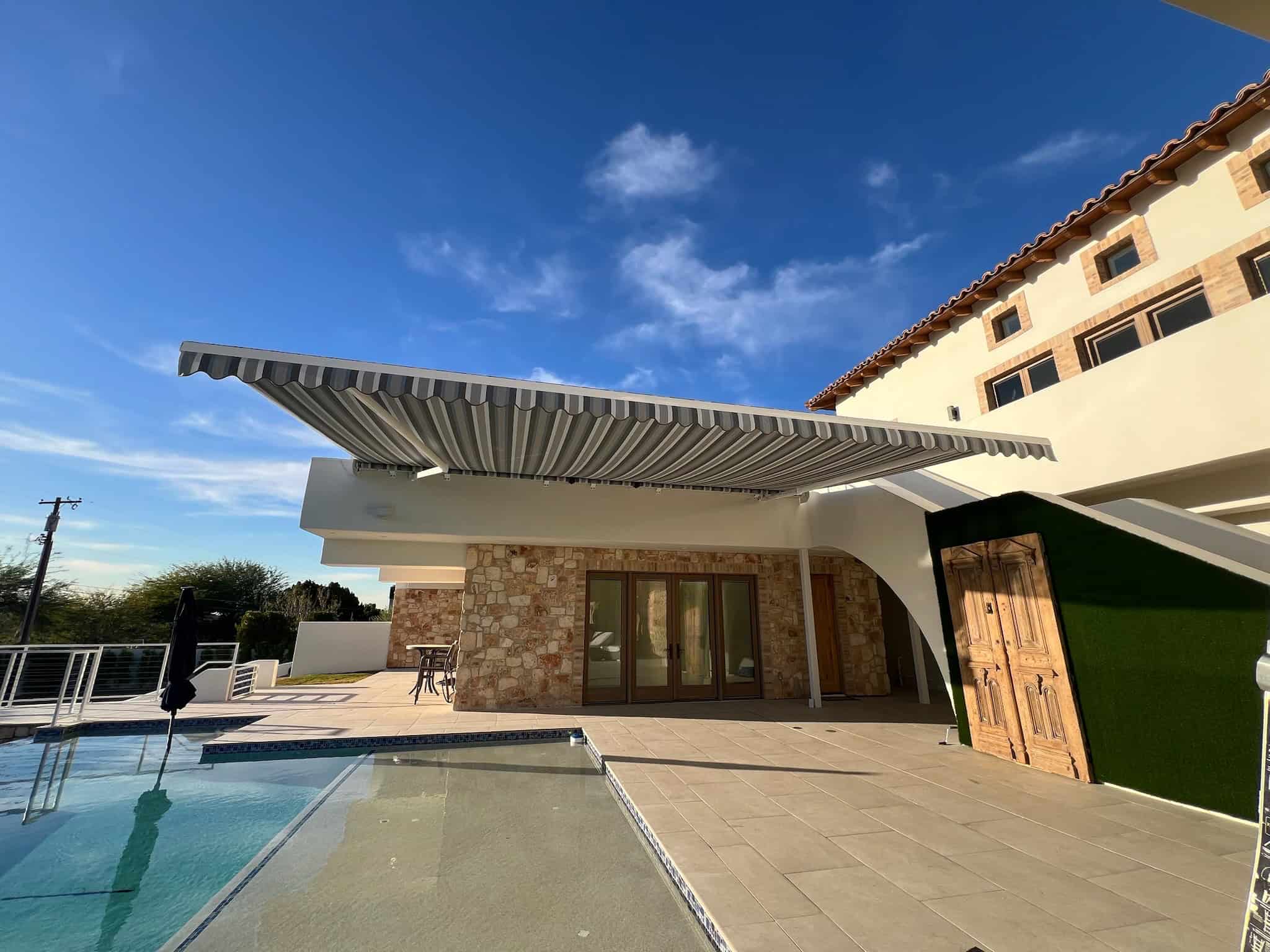 Modern Home With Retractable Awning Over Poolside Patio