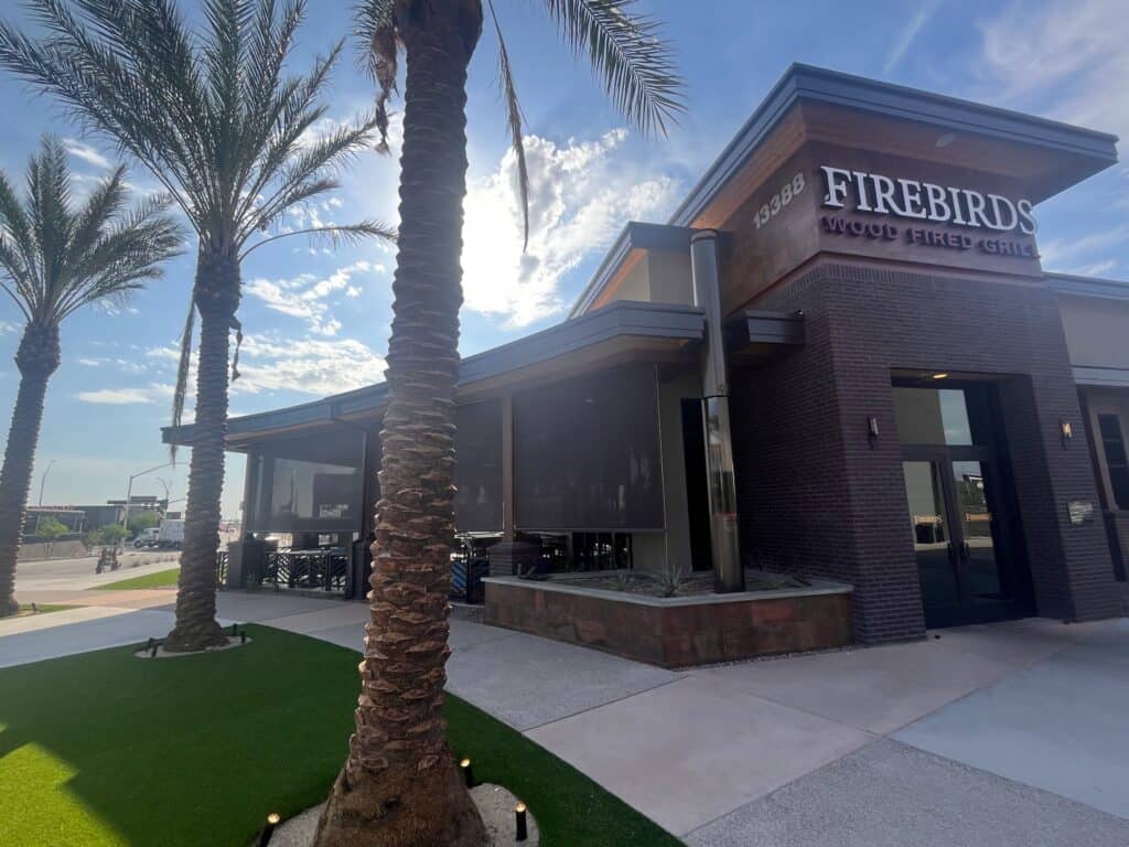Patio Shades Installed on a Restaurant Building to Control Sun Exposure and Improve Outdoor Seating Comfort