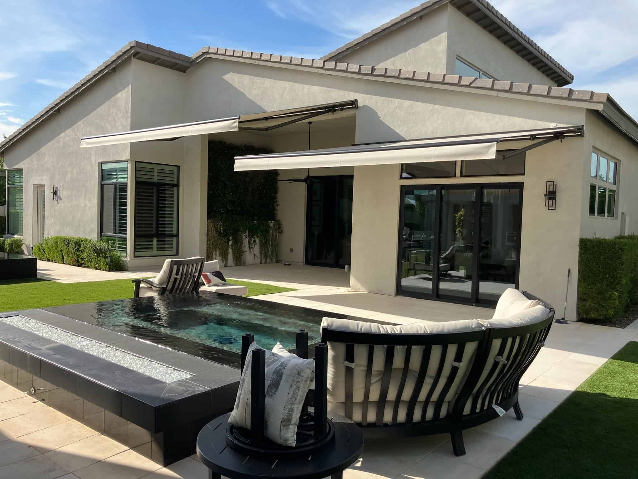 Motorized Awnings Extending Over Modern Home Patio