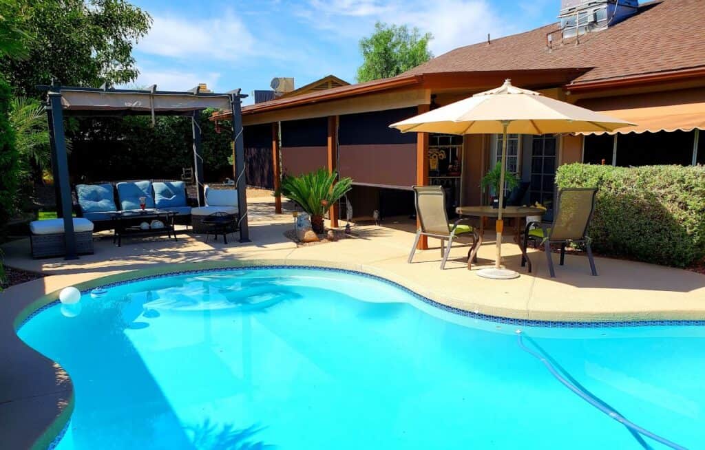 Backyard Patio With Retractable Shades Over Outdoor Seating