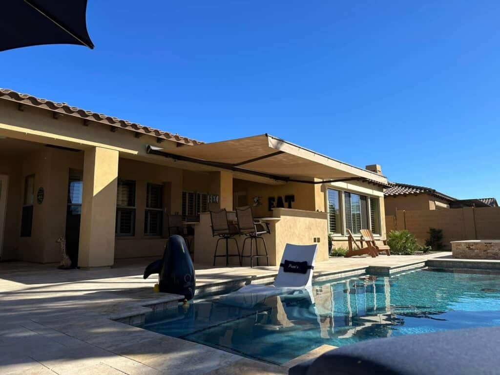 Retractable Awning Covering an Outdoor Bar and Dining Zone in a Luxury Paradise Valley Backyard