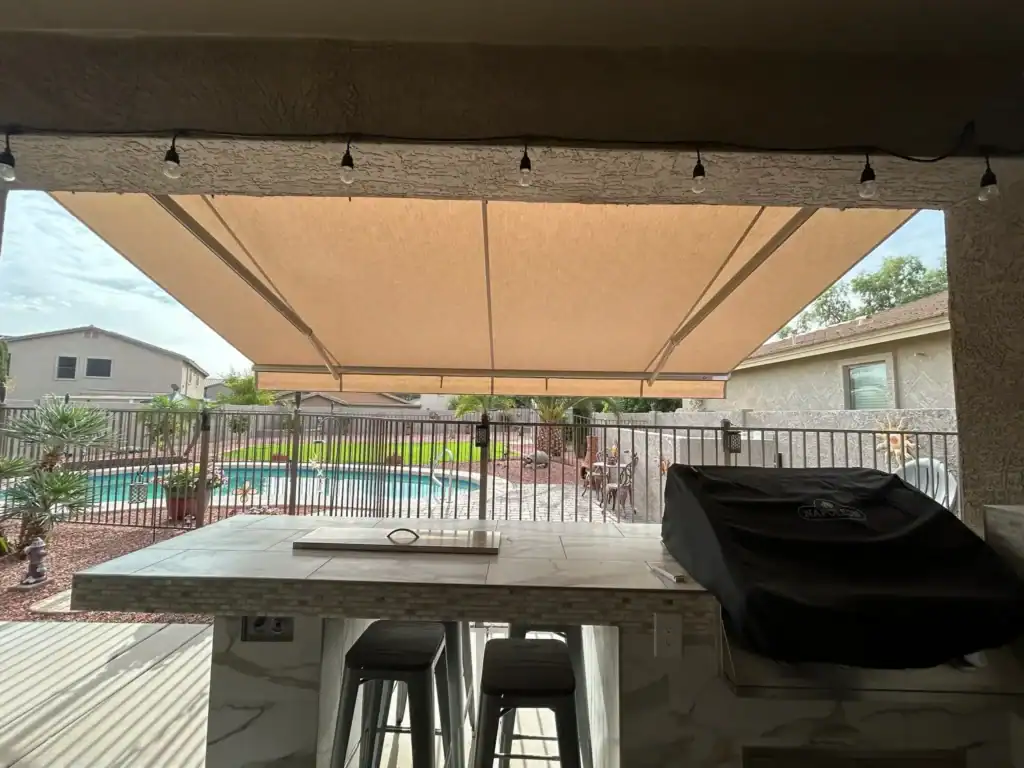 Retractable Awning over Outdoor Kitchen and Pool Area